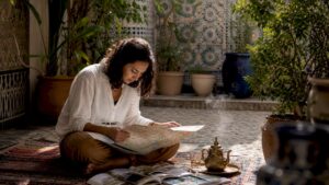 Traveler planning Morocco trip with map and brochures